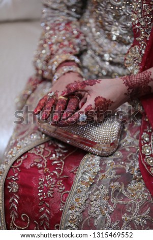 bride's hands picture touching wedding ring. Bride's wedding dress design is also shown
