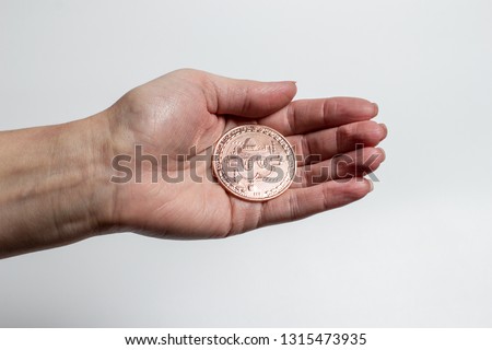 Hand holds bitcoin