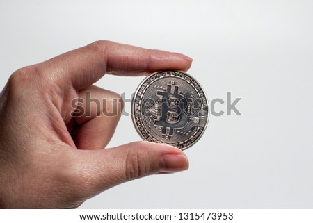 Hand holds bitcoin