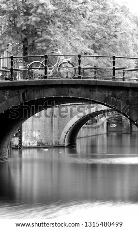 The bicycle on an bridge over a canal in Amsterdam Royalty-Free Stock Photo #1315480499