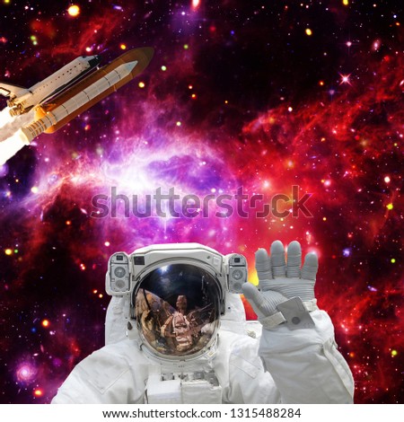Astronaut posing. Rocket on the backdrop. The elements of this image furnished by NASA.