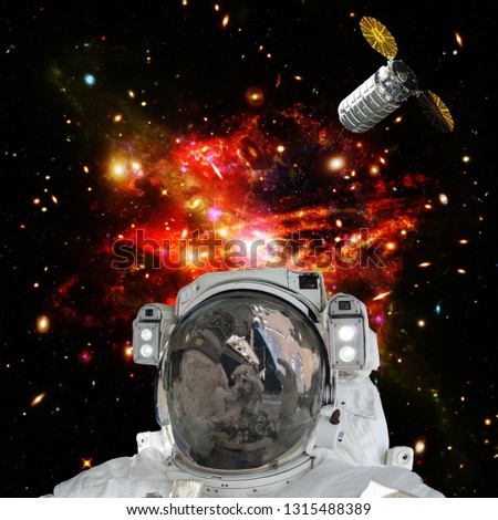Astronaut posing against galaxies and stars. Outer space. The elements of this image furnished by NASA.