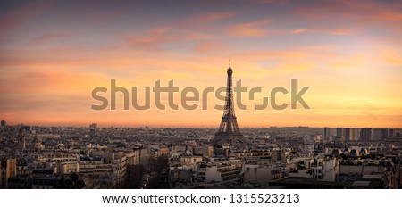Panoramic aerial view of Paris, France, with the Eiffel Tower and the many city rooftops at sunset. Very High Resolution.