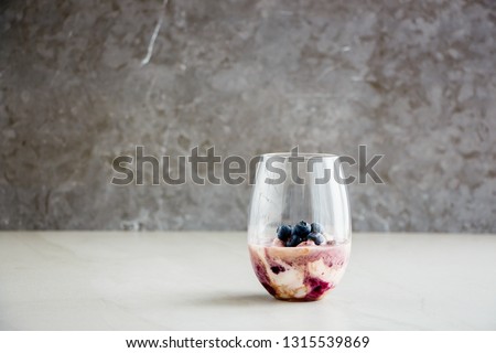 Homemade blueberry dessert in glass with fresh berries, grey background. Summer refreshing desert - Image  