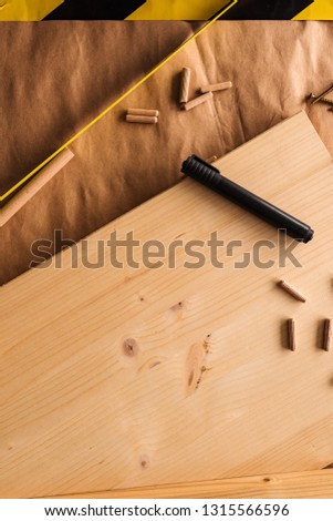 Felt tip pen on woodwork carpentry workshop table with other tools of trade for diy hobby project