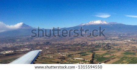 Popocatépetl and Iztaccihuatl volcanos picture take from an airplane.  A smoke plume emanating from Popocatépetl can be seen.
Puebla, Mexico
February 11, 2016