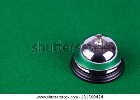 Silver alarm service bell on green background