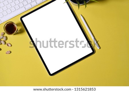 Blank screen tablet on the pastel background and copy space