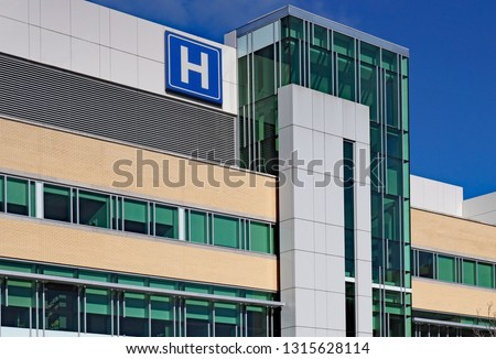 Modern style building with large H sign for hospital