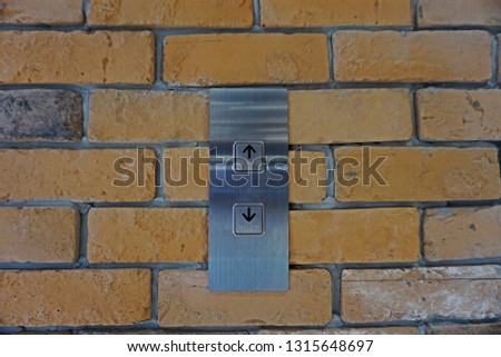 Elevator buttons on the old brick wall