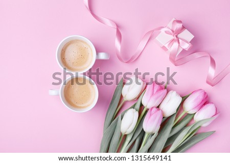 Women day 8 March concept. Morning coffee, gift box and spring tulip flowers on pink pastel background. Flat lay.