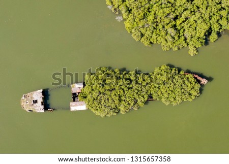 shipwreck of the SS Ayrfield on the Parramatta river Sydney, Australia.    Originally launched as the SS Corrimal, the massive 1,140-tonne steel beast was built in 1911 in the UK Royalty-Free Stock Photo #1315657358