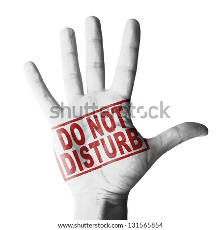 Hand raised with Do Not disturb tag painted - isolated on white background