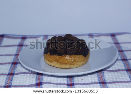 Sweet donuts and chips on color wooden table - Image