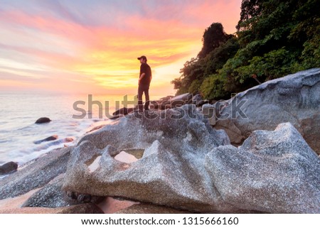 Silhouette view of male model photographer by sunrise or sunset background