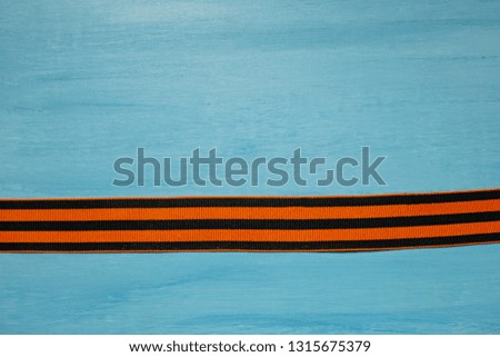 May 9 russian holiday, victory day, banner or poster. St. George striped ribbon on blue background.
