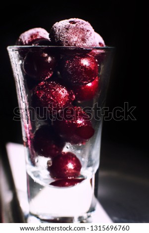 frozen cherry  close in a glass on a dark background