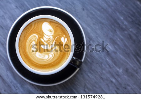 a cup of hot latte art coffee