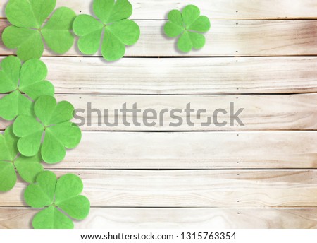 St. Patrick's Day Background with Green Shamrocks leaves on Wooden Texture
