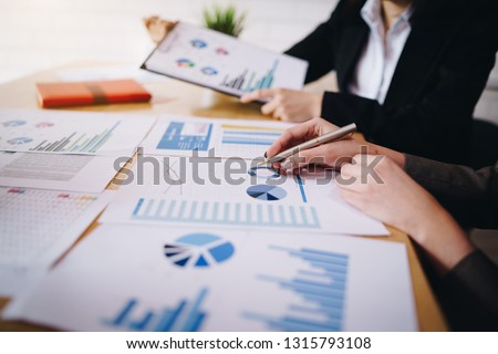 Businesswoman pointing pen on business document at meeting room. Discussion and analysis data charts and graphs showing the results at meeting. Royalty-Free Stock Photo #1315793108