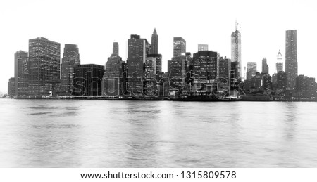 Panoramic view of the world famous skyline of New York Financial District and the Lower Manhattan at dawn. High key black and white image.