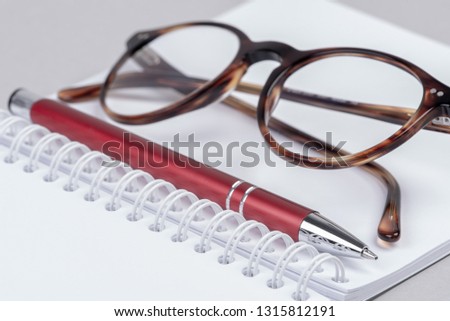 Personal accessories for work in office, notebook, pen and glasses