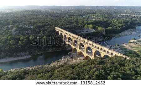 Aerial bird view photo of Pont du Gard is ancient Roman aqueduct that crosses Gardon River near towns of Remoulins Avignon and Nimes in southern France it is on UNESCO's list of World Heritage Sites