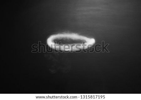 white oval ring of smoke on dark background Royalty-Free Stock Photo #1315817195