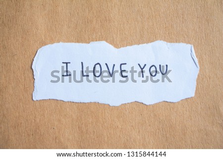 text I love you on brown paper.