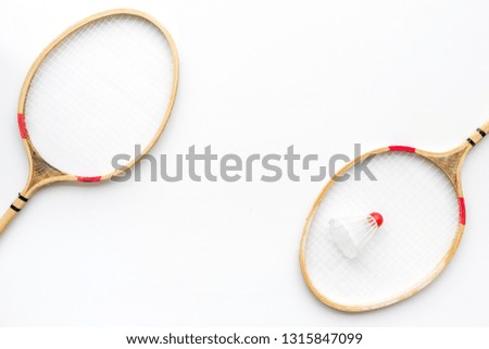 Badminton concept. Badminton rackets and shuttlecock on white background top view copy space pattern