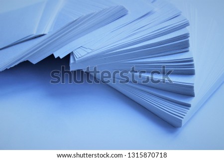 White sheets of paper on white background. Cool shades.
