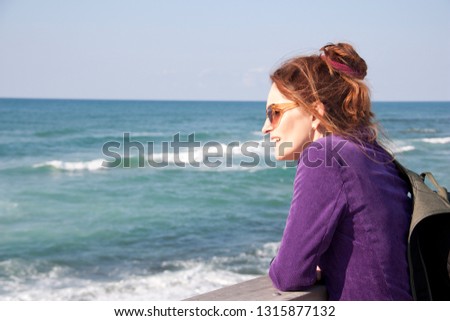 Portrait of a female tourist on a blurred sea background