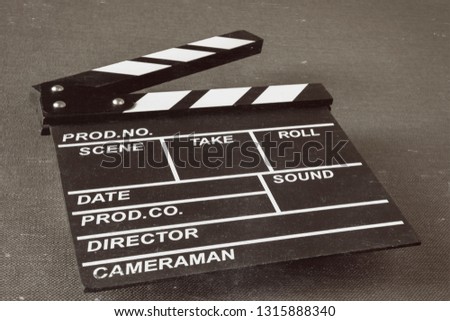 Clapperboard shot in perspective on the table. A stylized photo.