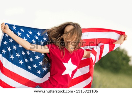 Young woman running with waving american flag