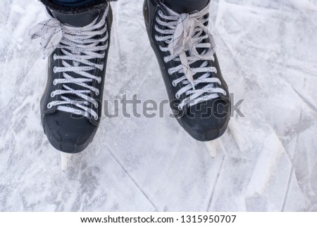 Man's hockey skates on ice background. People skate on the rink.