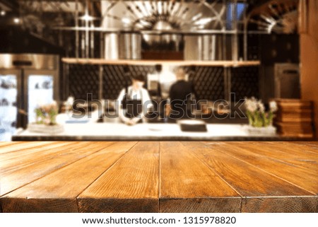Wooden table background of free space for your decoration. Restaurant kitchen interior and cook. 
