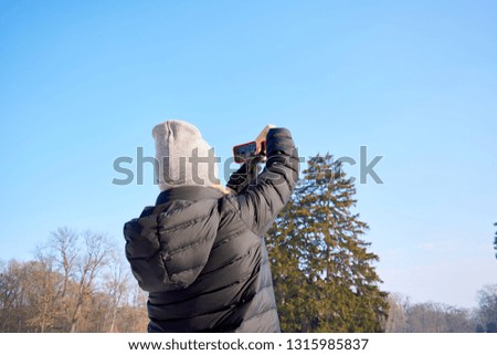 Woman taking a picture of the view with a mobile phone