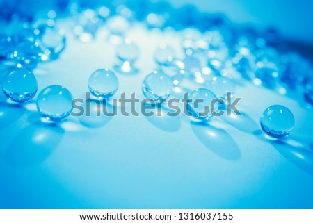 Bright blue hydrogel round shape on white background. Macro gel balls. Concept purity and minimalism. Classic cold abstract holiday wallpaper