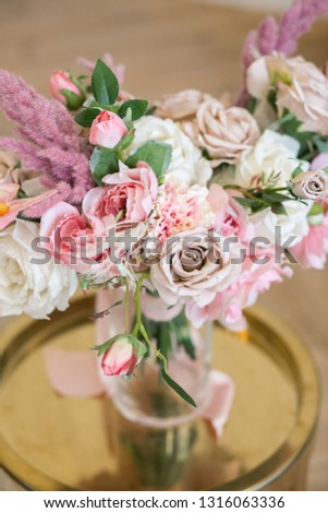 Wedding decoration of flowers close up . Beautiful bouquet on a stand. Classic interior. Vertical orientation