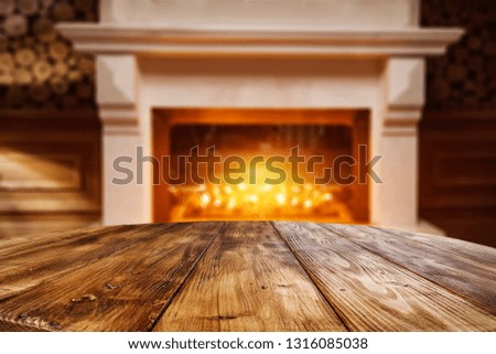 Wooden table of free space for your decoration and fireplace background. 