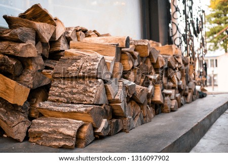 A stack of beautiful wood. chopped and ready firewood for the kindling of the fireplace lie beautifully. natural energy