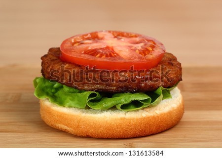 Making Hamburger. Macro. Series. 10/12. Tomato on Patty.