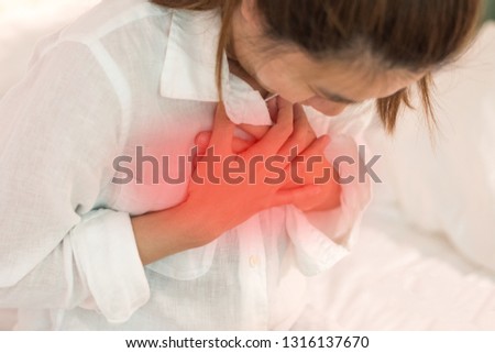 Woman's hand on chest with red spot as suffering on chest pain. Female suffer from heart attack,Lung Problems,Myocarditis, heart burn,Pneumonia or lung abscess, pulmonary embolism day Royalty-Free Stock Photo #1316137670