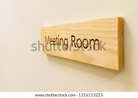 Wooden sign with the word Meeting Room