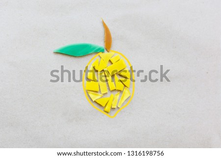 Lemon is made of yellow mosaic on gray paper.