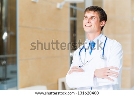 Portrait of a doctor standing in the office and crossed his arms