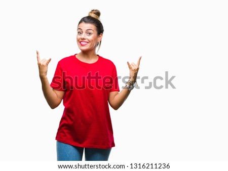 Young beautiful woman over isolated background shouting with crazy expression doing rock symbol with hands up. Music star. Heavy concept.