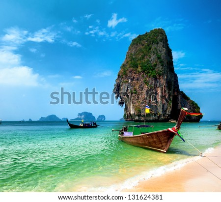 Thailand sandy beach and traditional thai wooden boat
