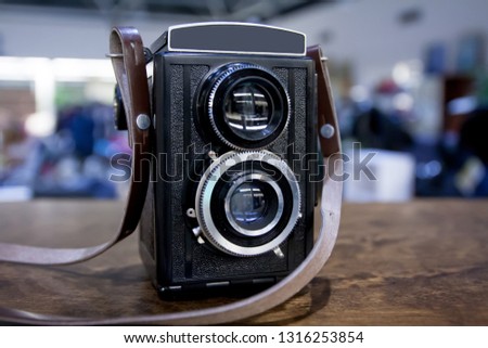 Vintage twin lens camera on the table.