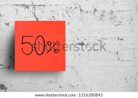 Sticky note on concrete wall, 50 Percent 